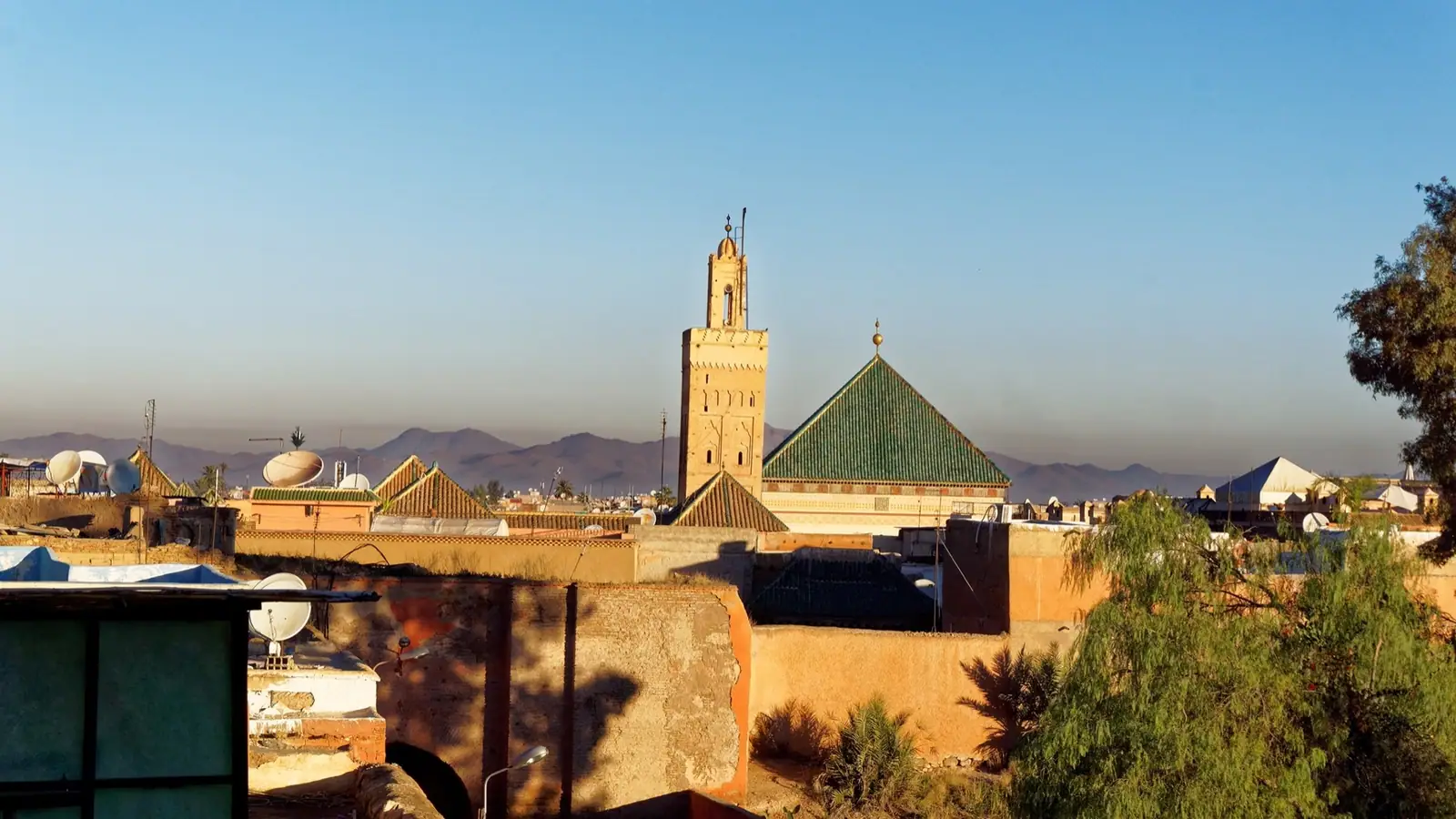 The Zawiya of Sidi Bel Abbès above the Marrakech medina, with the Atlas mountains behind.